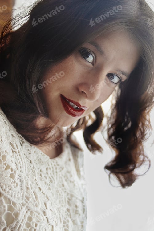 Preview: happy stylish outstanding vintage brunette girl with curly short hair and red lips in the morning