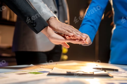 Preview: Three people are shaking hands in a business meeting
