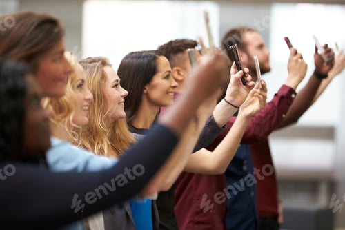 Preview: Row of students at university taking photos with smartphones