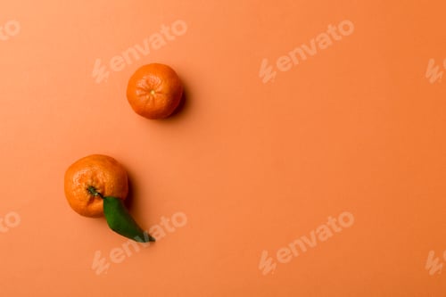 Preview: Many fresh ripe mandarin with green leaves on colored background, top view, space for text