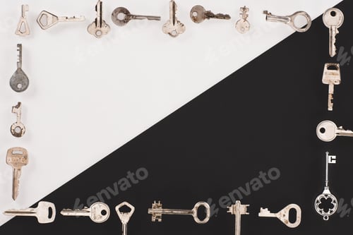 Preview: top view of different vintage keys frame over black and white background