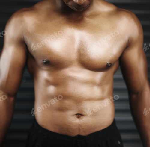 Preview: Hes all muscle. Cropped shot of a shirtless man with defined abs.
