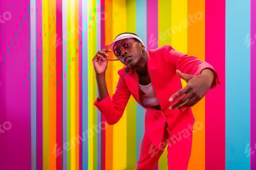 Preview: Beautiful young woman dancing and having fun inside a rainbow box room