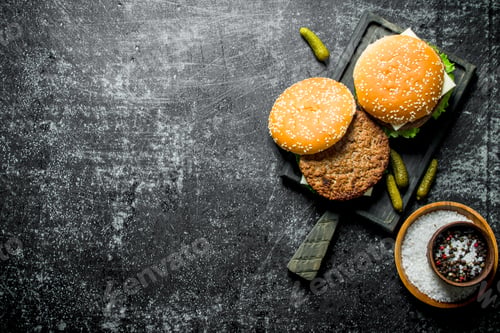 Preview: Burgers on the cutting Board and spices in the bowl.
