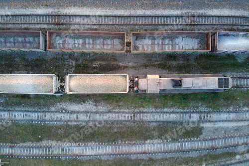 Preview: Aerial view of cargo train loaded with crushed sandstone materials at mine factory.
