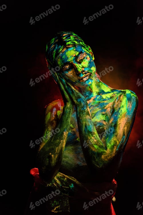 Preview: portrait of beautiful woman with colorful ultraviolet paints on body on black backdrop