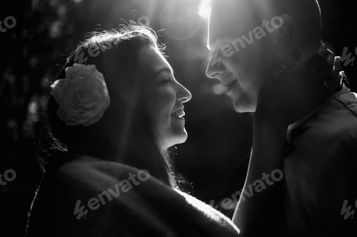 Preview: beautiful stylish brunette bride and elegant groom in embroidery costumes having fun in the park