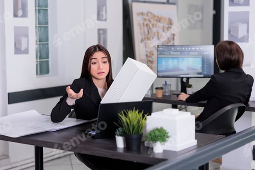 Preview: Architect showing building 3d printed model on online meeting