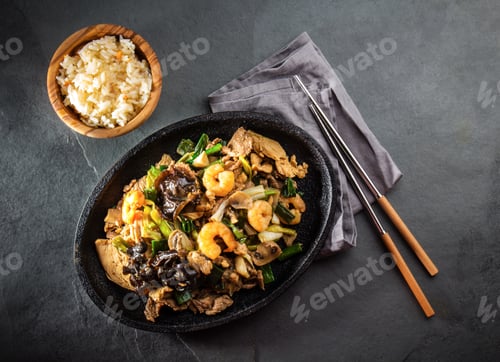 Preview: Chinese food. Te pam sao. Pan of fried different meat, shrimps shiitake mushroom