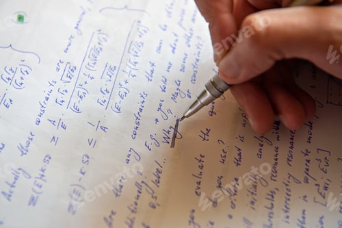 Preview: Student writing mathematical calculations on paper, closeup