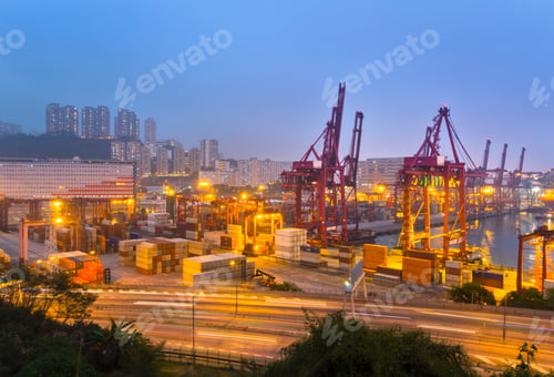 Preview: Cargo containers and loading cranes illuminated at night, Hong Kong, China