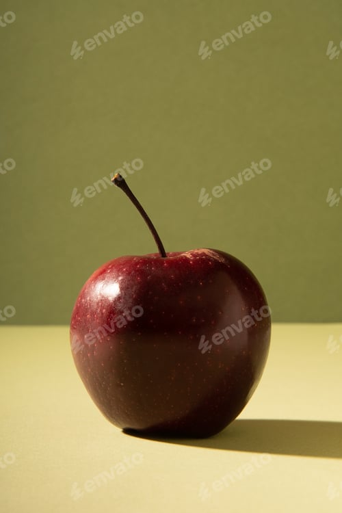Preview: Useful red fresh apple on a gentle green background with a shadow.