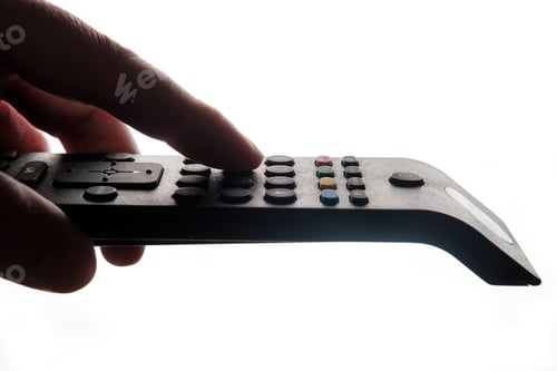 Preview: Hand holding tv remote isolated on white background.