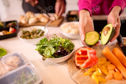 Preview: Close Up Of Couple In Kitchen Wearing Fitness Clothing Making Batch Of Healthy Meals For Freezer
