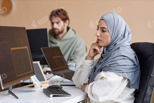 Preview: Muslim Woman as Female Programmer Looking at Computer Screen