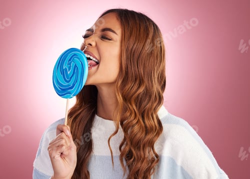 Preview: Candy, lollipop and woman in studio with sugar snack, happy and having fun against a pink backgroun