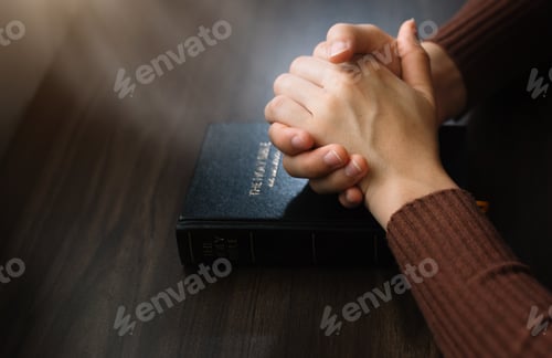 Preview: woman hands praying to god with the bible.