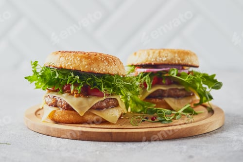 Preview: Two Tasty Burgers on Wooden Board