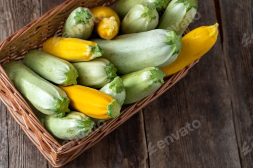 Preview: Multi-colored zucchini yellow, green, white, orange on the wooden table close-up. Food background