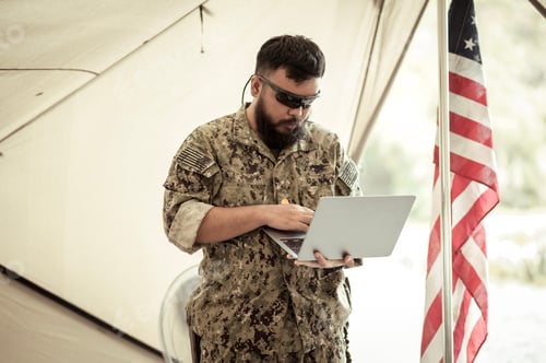 Preview: Soldiers in camouflage uniforms planning on operation in the camp
