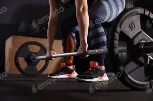Preview: Sportswoman with barbell during workout in gym, closeup