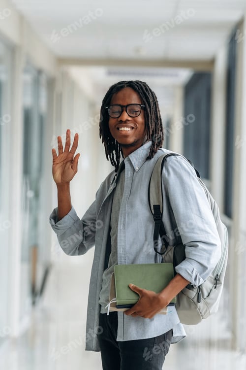 Preview: Bye hand gesture, smiling. Student with backpack is in the corridor