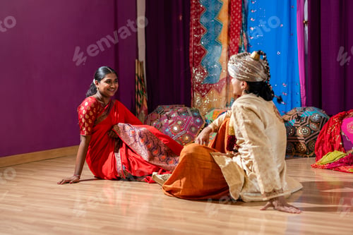Preview: happy indian couple in traditional clothes wedding event sitting on the floor
