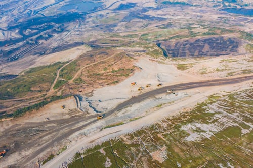 Preview: Machine excavator trucks dig coal mining or ore in quarry with mountain hills. Factory industry.