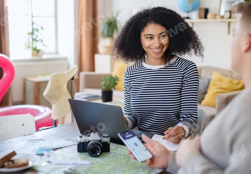 Preview: Young couple with laptop packing for holiday, coronavirus concept
