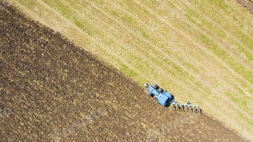 Preview: Aerial top view of a tractor on an industrial field