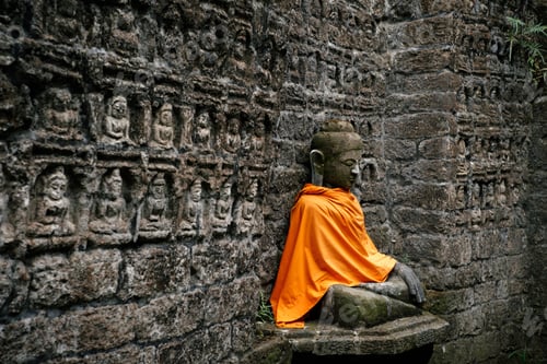 Preview: Ancient Buddha statue in orange cover