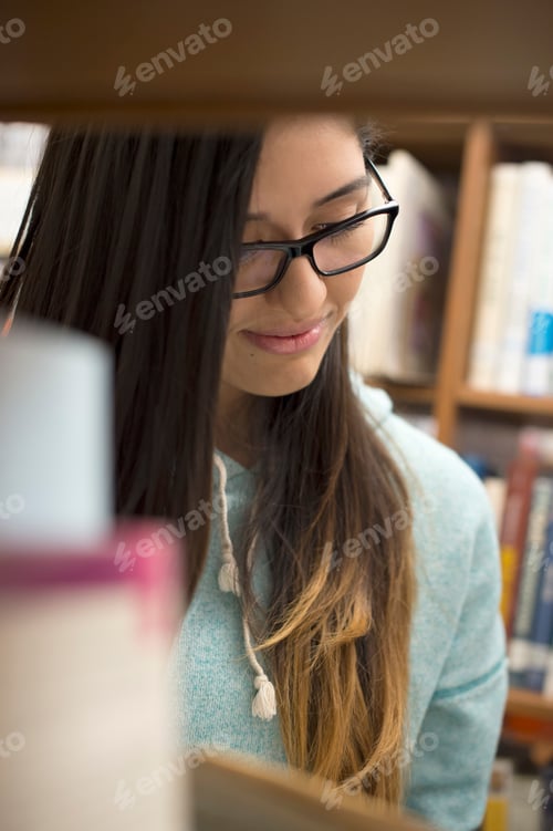 Preview: Young woman reading book