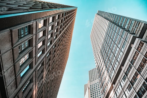 Preview: A city skyline with three tall buildings, one of which is a large glass building