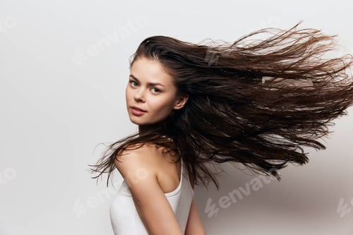 Preview: Woman with flowing hair against a light background, showcasing natural beauty and movement, ideal
