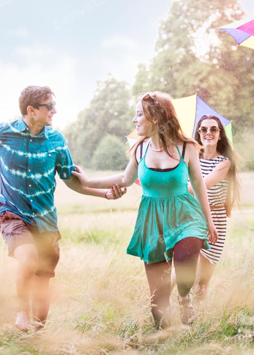 Preview: Friends walking in field smiling