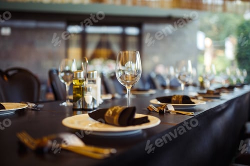 Preview: Sparkling glassware stands on long table prepared for wedding dinner.