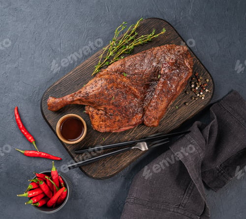 Preview: BBQ roast duck or chicken in spices and marinade on a wooden board with fresh spices