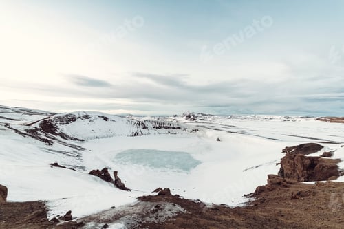 Preview: Frozen lake in a snowy landscape with clear skies.