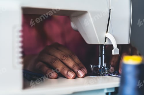 Preview: Woman working with sewing machine doing homemade medical face mask