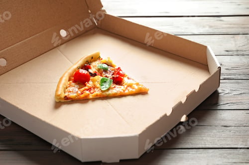 Preview: Last slice of tasty pizza in cardboard box on table