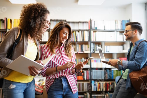 Preview: Group of college students studying in the school library