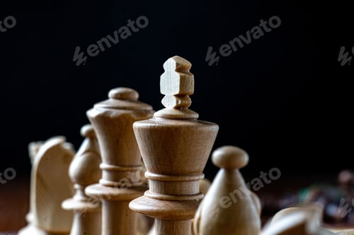 Preview: a macro shot of the chess pieces on the board on dark background