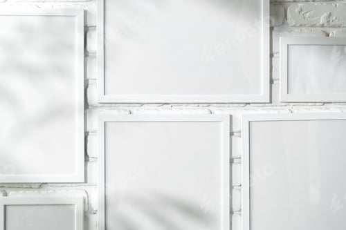 Preview: Varied Sized Photo Frames Displayed on a White Brick Wall