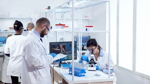 Preview: Male scientist using tablet pc for genetic study