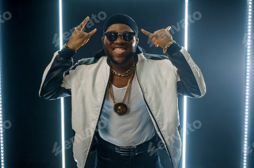 Preview: Smiling rapper on the stage with illuminated cube