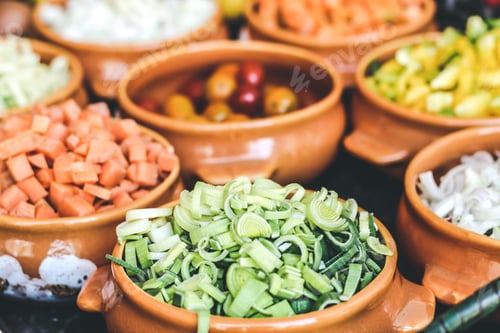 Preview: Chopped fresh vegetables on orange bowls