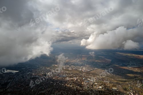 Preview: Aerial view from airplane window at high altitude of distant city