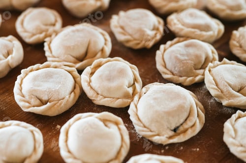 Preview: pile of homemade food dumplings on kitchen table. national traditional Russian cuisine. diy