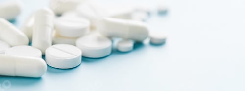Preview: Banner with White Pills on Blue Background.