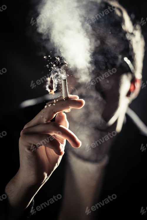 Preview: Man in eyeglasses smoking cigarette between smoke